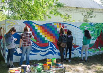 (Los estudiantes y profesora en pleno proceso del mural)